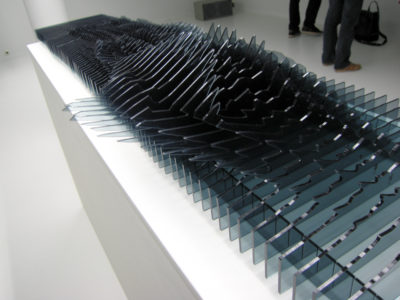 Une forme d'onde sonore représentée avec des lames en plexiglass